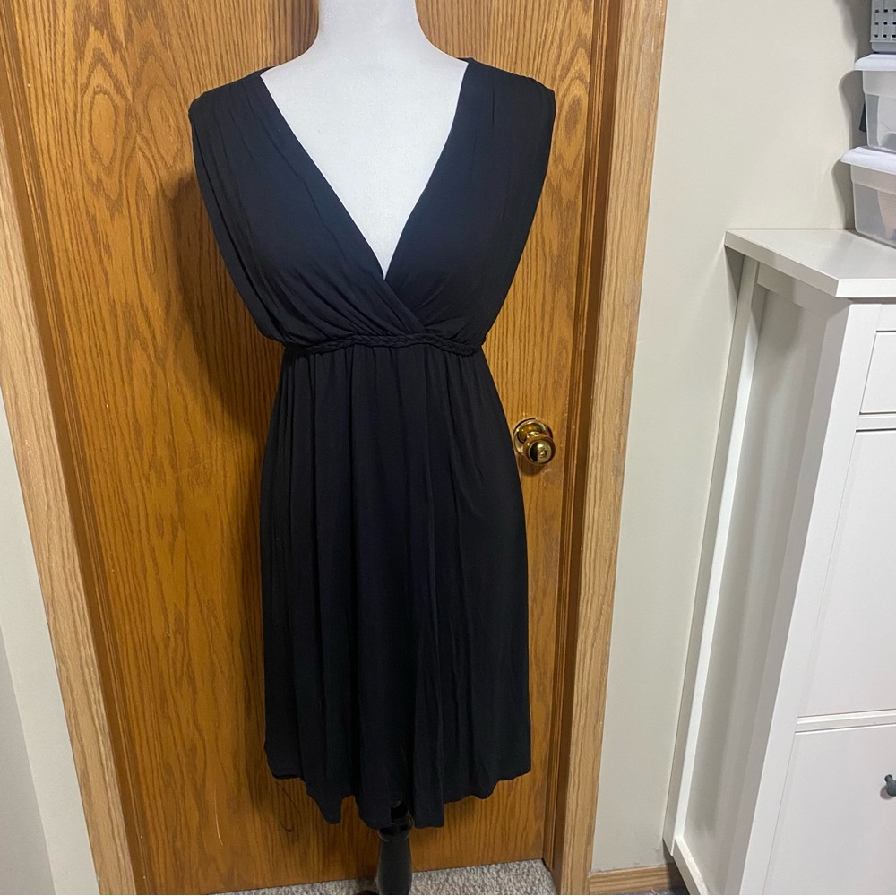Cute black dress with braid detail under bust with tin the the back